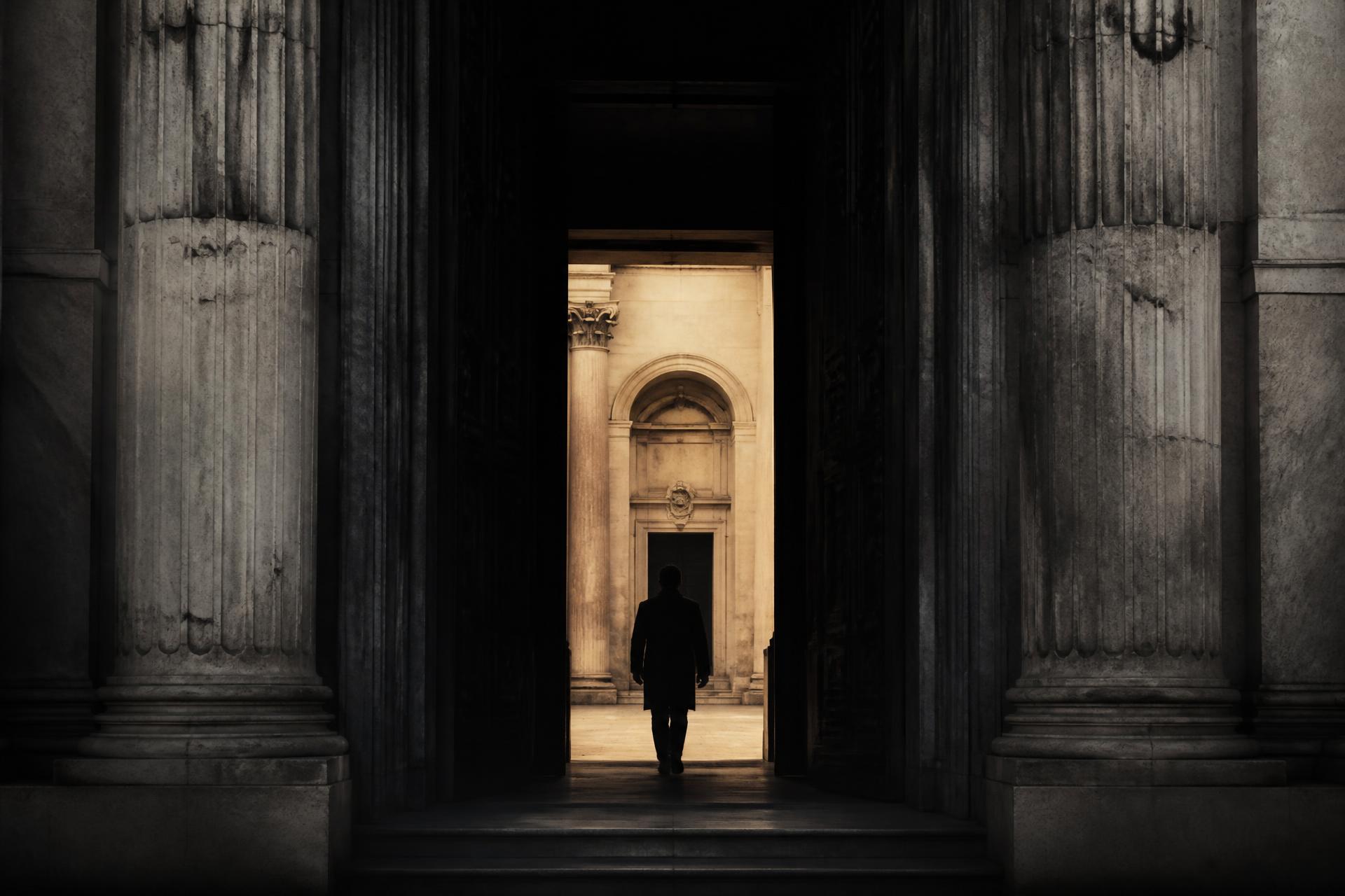 A stone doorway with warm light beyond it